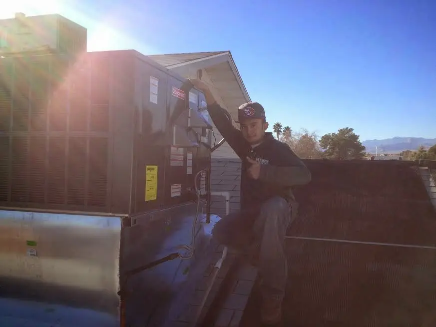 HVAC technician performing AC Tune-Up on a rooftop unit in Euclid